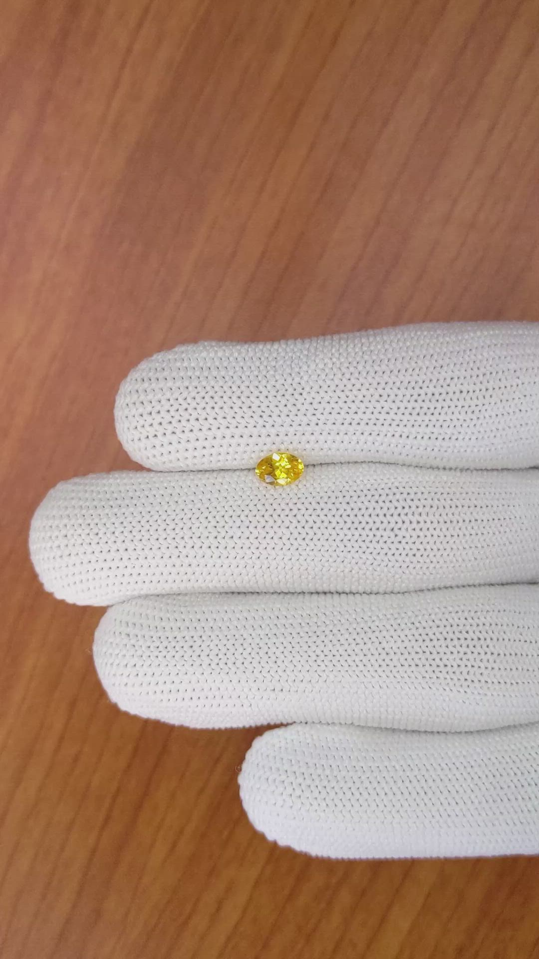 0.60 Ct. Orangish Yellow Sapphire from Ceylon (Sri Lanka) Size Video