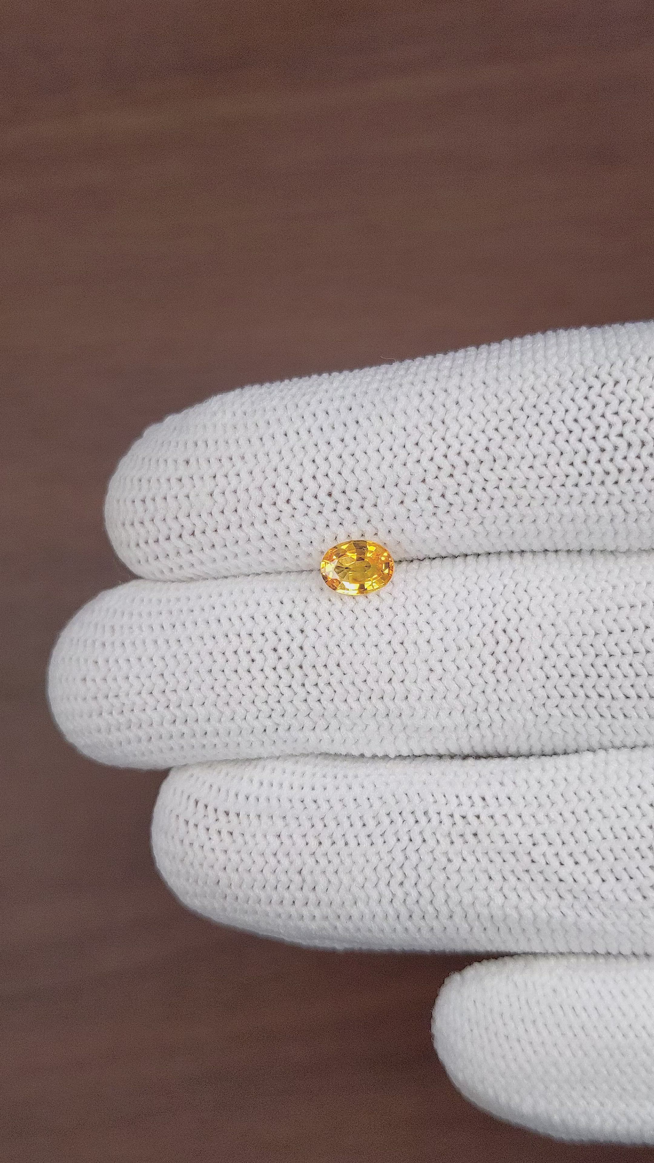 0.69 Ct. Orangish Yellow Sapphire from Madagascar Size Video