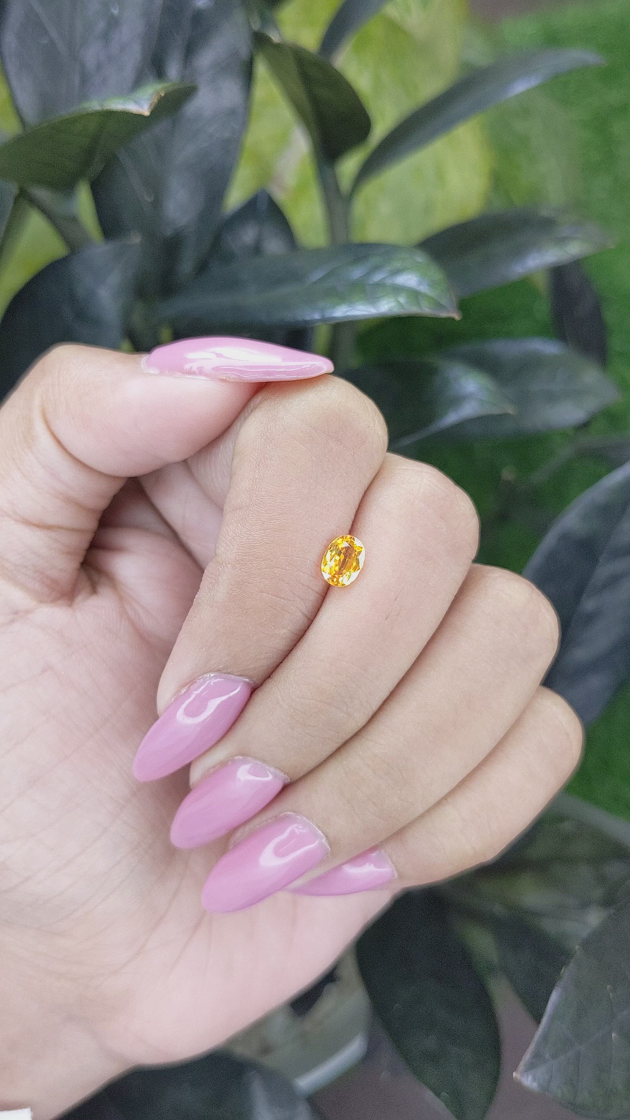 0.69 Ct. Orangish Yellow Sapphire from Madagascar Size Video