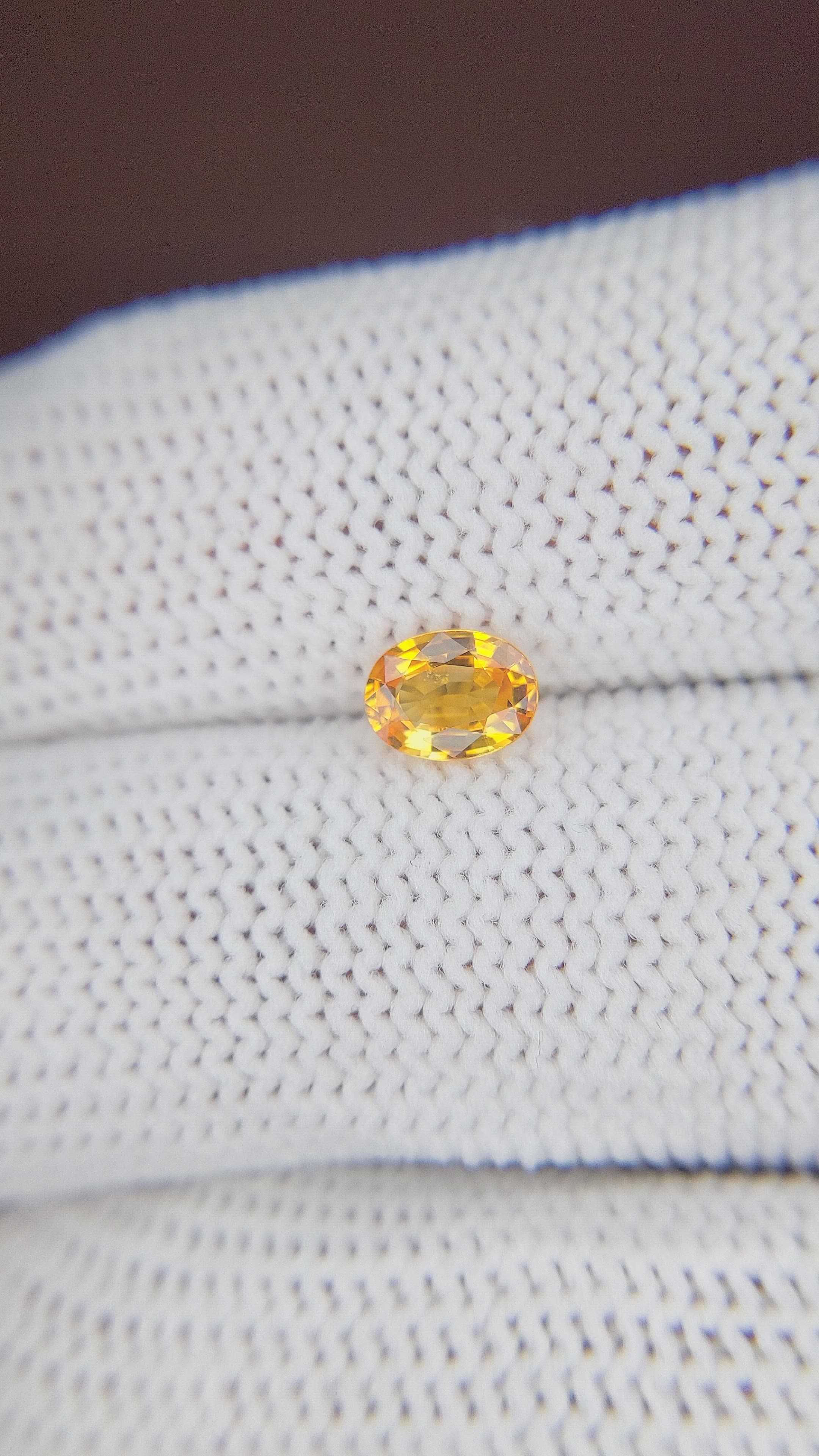 0.69 Ct. Orangish Yellow Sapphire from Madagascar Size Video