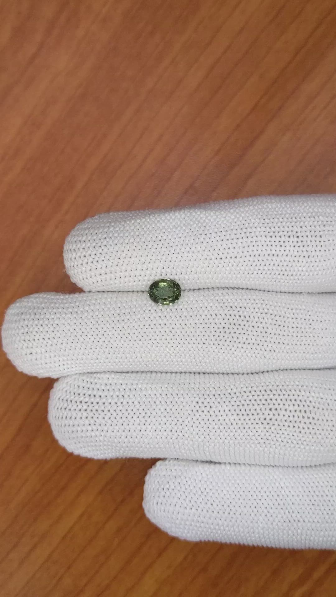 0.84 Ct. Brownish Green Sapphire from Madagascar Size Video